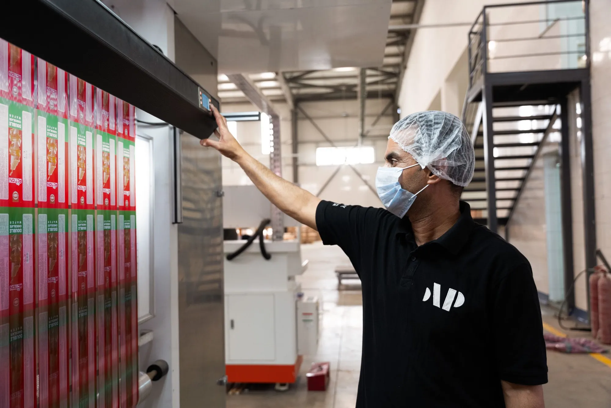 A press operator at the controls as printed film runs through the press
